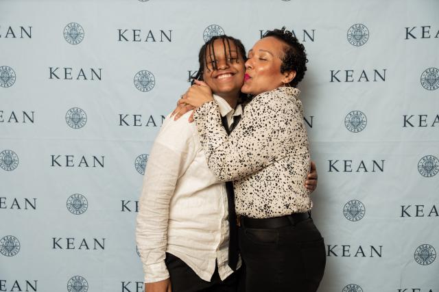 A mother kisses her son who was inducted into the honor society.