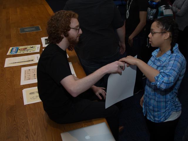 Alumnus Max Friedman talks with a design student at the Thinking Creatively Conference.