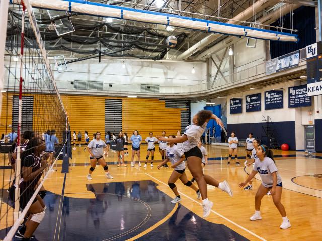Students play volleyball at Harwood Arena in Kean's KUBS volleyball clinic.