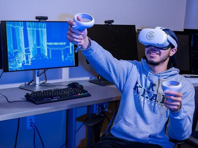 Student using VR equipment in computer lab