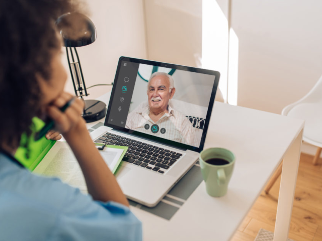 Elderly man receives telehealth services from a counselor