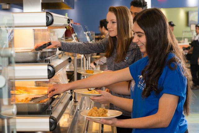 Students serve themselves in the cafeteria line