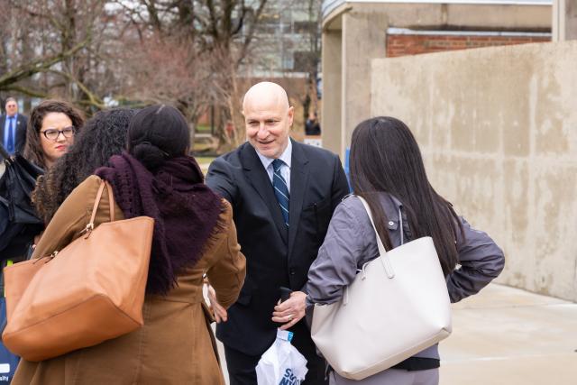 Chef Tom Colicchio talks with three Kean University students on the Union campus.