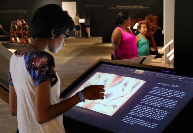 People interacting with Da Vinci exhibit