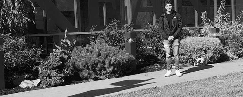 Student outside of Harwood Arena
