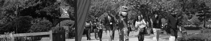 Students walking on campus towards flower garden