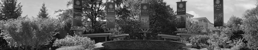 The fountain on Kean's campus, with flags displaying names of the Kean campuses