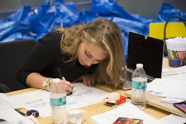 A Robert Busch School of Design student sketches at her desk.