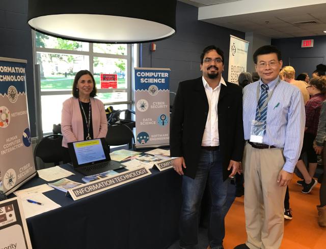 Computer Science table with 3 faculty standing at the Fall '18 Expo