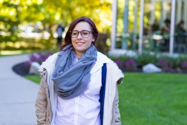 Female Kean student walking along Cougar Walk