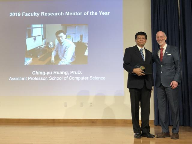 Photo of Ching-Yu Huang, Ph.D. with Provost Toney receiving the Faculty Research Mentor of the Year Award