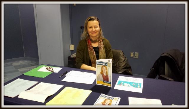 Photo of Chemistry representative sitting at a table at the Major Minor Expo March 30 2019 with Guidesheets and brochures