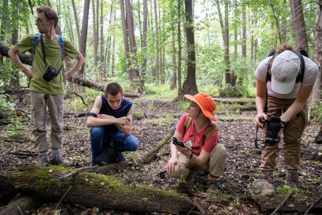 Prof. Maria Shumskaya teaching outside in the field around trees in the State Biosphere Reserve, Russia