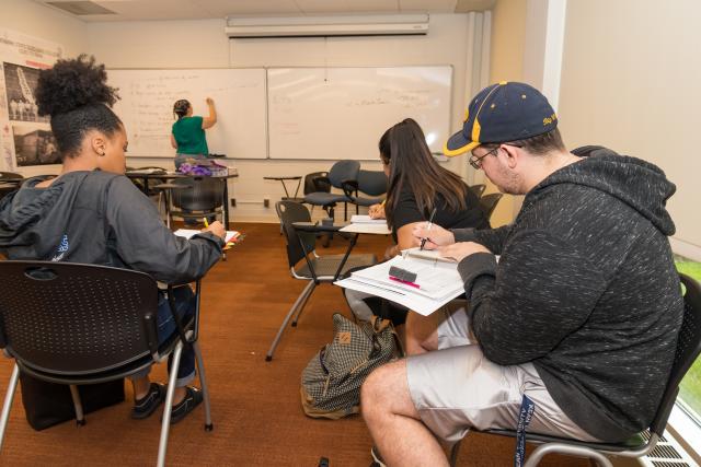 Students taking notes in a classroom 