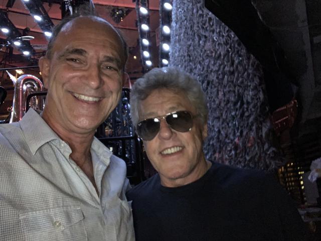 Professor James Musto is on the left smiling next to The Who member Roger Daltrey