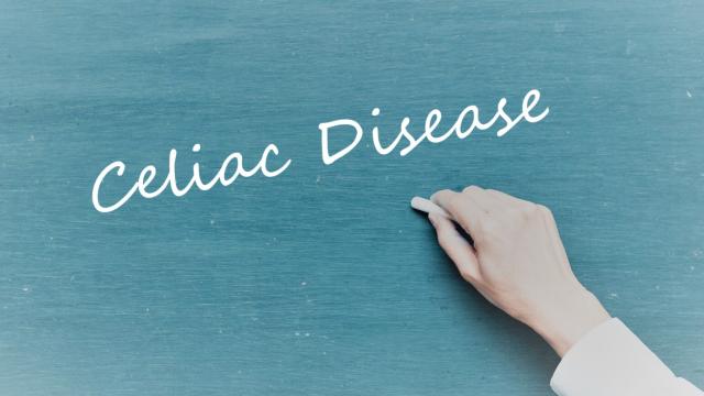 A hand writing Celiac Disease on a Blackboard