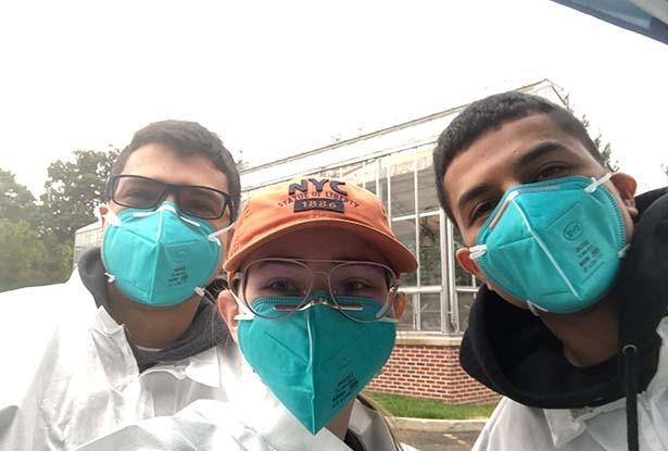 Three Kean students - two male and one female - in protective gear and wearing face masks.