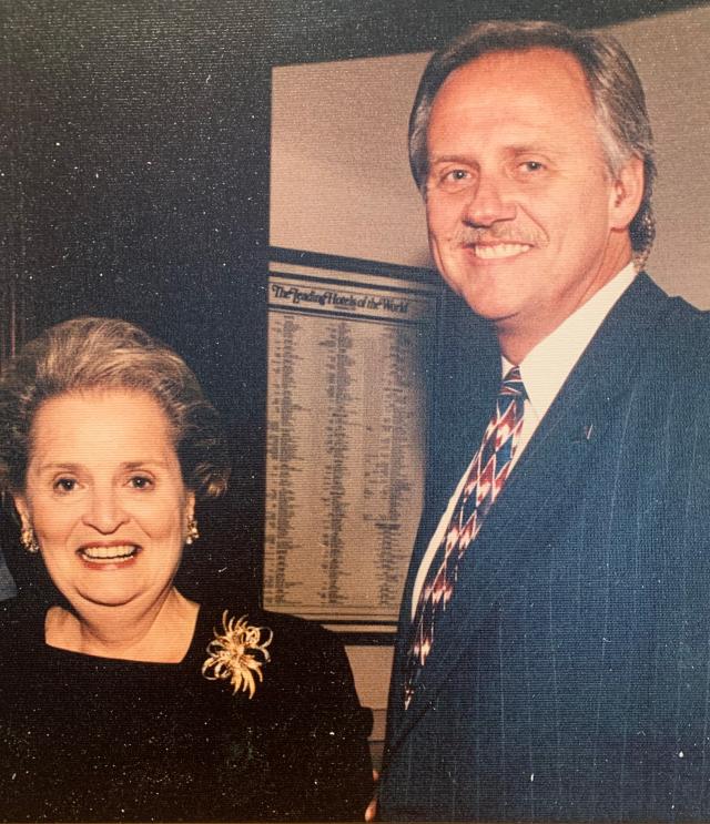 Madeleine Albright and George Gilcrest stand next to each other, smiling.
