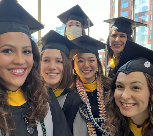 Six women in black caps and gowns, smiling