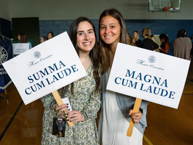 Honors convocation students holding signs