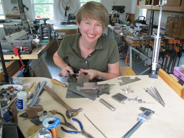 Kean professor Jennifer Crupi, a metalsmith, at work in her studio