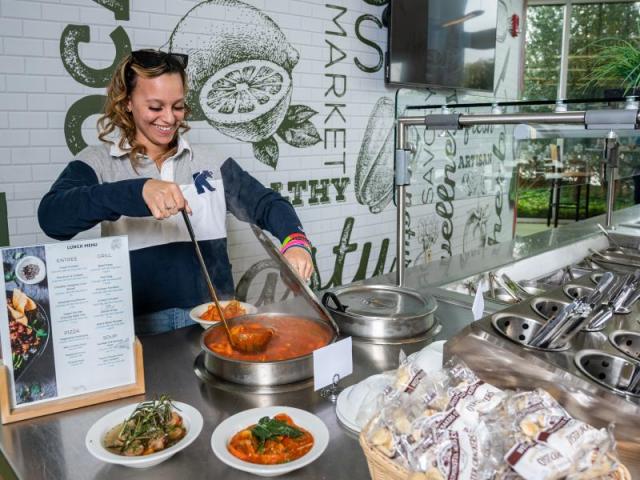 A woman prepares food at Keanu's Kitchen