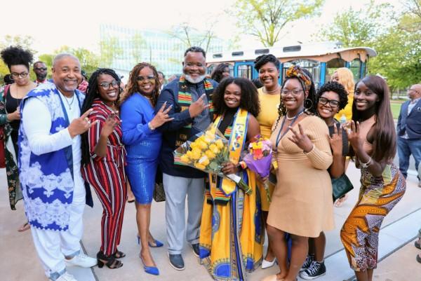 President Repollet joins a festive family group at African Heritage Graduation