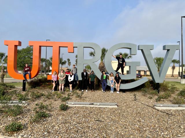 Students standing at the University of Tex Rio Grande Valley sign