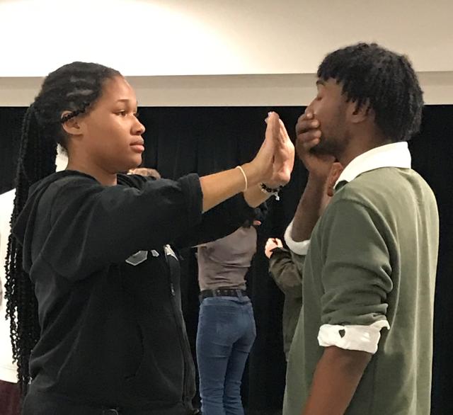 Two students practice preparing for a kissing scene