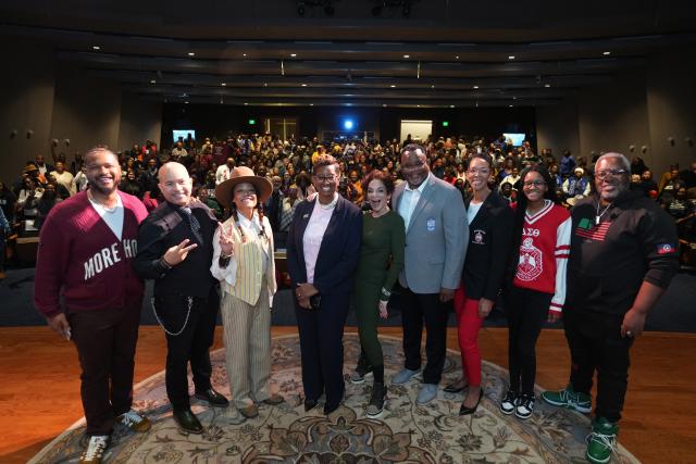 Prresident Repollet, his wife and daughter pose on stage with the A Different World cast.