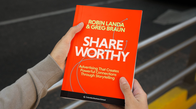 Hands holding an book entitled Shareworthy