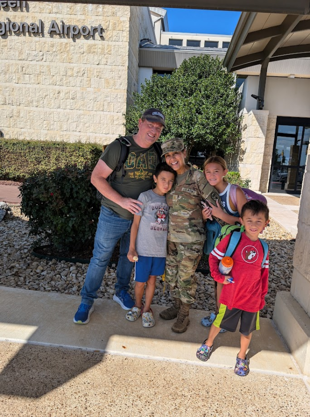 Maj. Kristine Sparks pictured with her family coming home