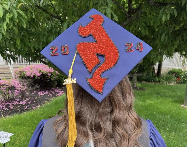 Christina Chiarella shows off her graduation cap, with NJ Devils logo, in 2024