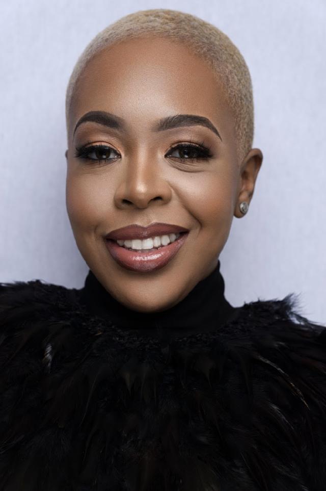 woman smiling wearing black turtleneck sweater