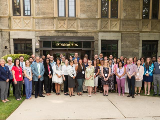 The new members of Kean University's faculty pose outside Kean Hall.