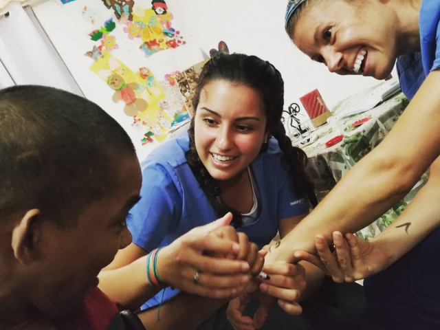 Two Kean occupational therapy students work with a client