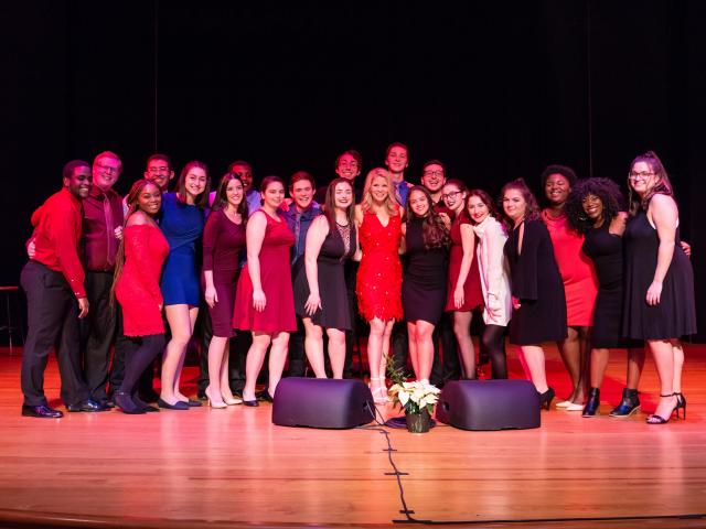 Kelli O'Hara poses with Kean students on stage