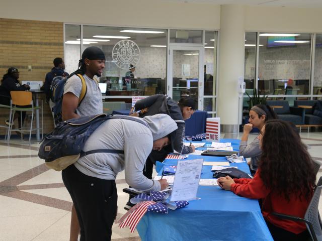 Students register to vote at a Kean University event.