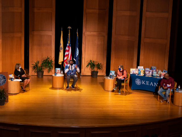 Sancha Gray, Dr. Repollet, Randi Weingarten and Ras Baraka, wearing face masks, sit on stage at Enlow Recital Hall.