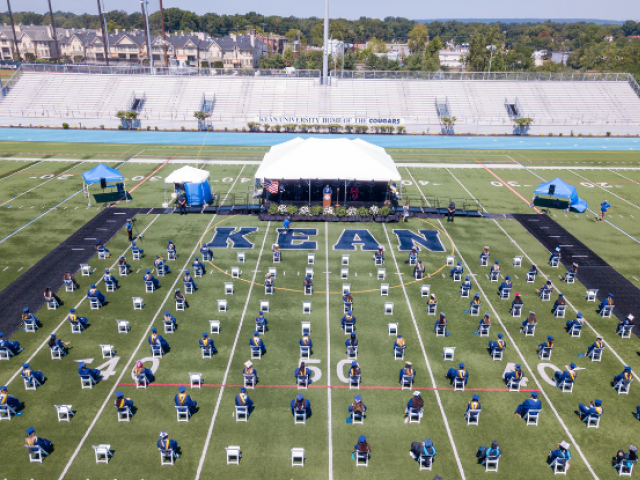 An overhead shot of 2020 Kean University graduates on the Alumni Stadium field at Commencement.