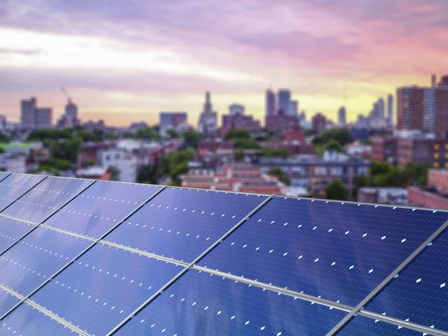 Solar panels and a city skyline