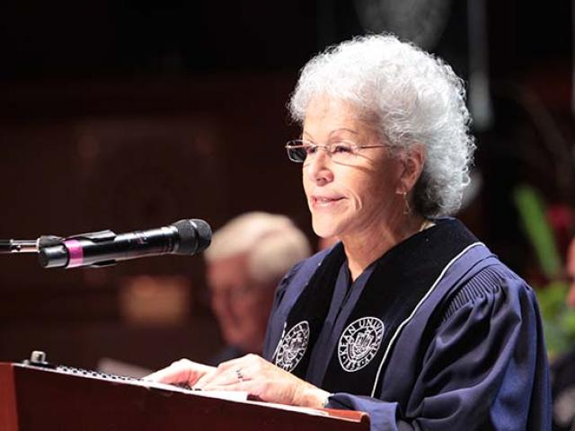 Former Kean University Board of Trustees chair Ada Morell speaks at a podium at Kean's commencement.