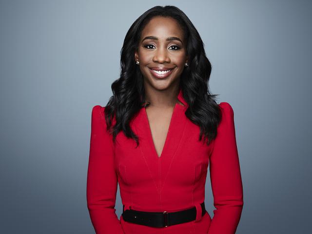 CNN's Abby Phillip wears a red dress with a black belt.