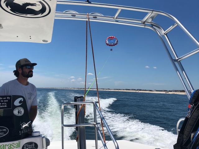 Christopher Titmas drives his boat with a parasailer