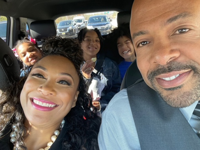 Roberta and Alvin Freeman in the front seat of car, with their three children behind them.