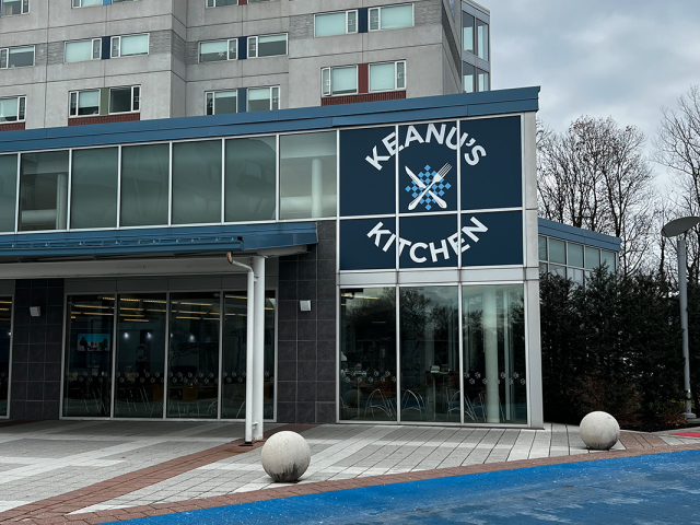 The outside of a building, with a sign reading Keanu's Kitchen.