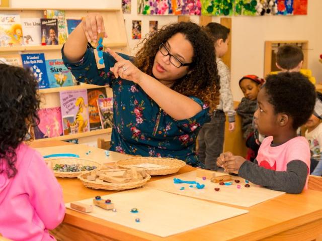 Teacher working with preschoolers at child care center