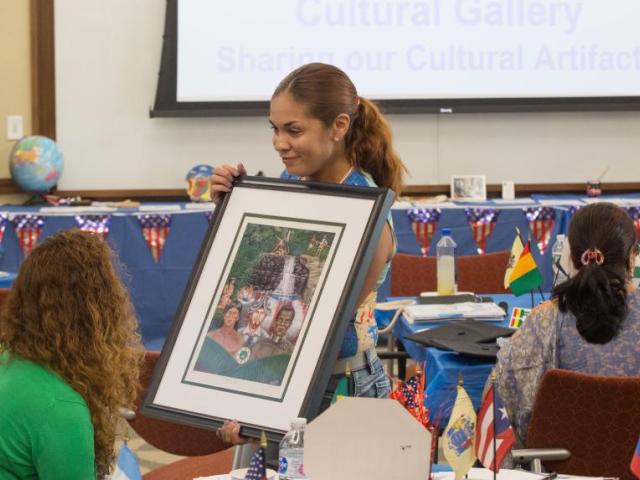 Debra Ramos a Program Graduate Shares a Cultural Item with student participants