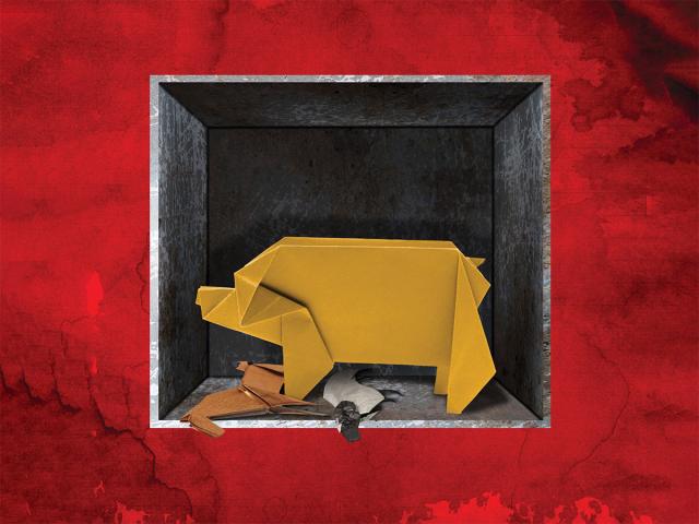 a paper pig within a black box and a red background