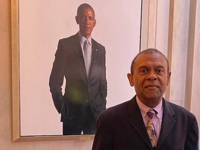 Nicky Sheats poses with Barack Obama's portrait